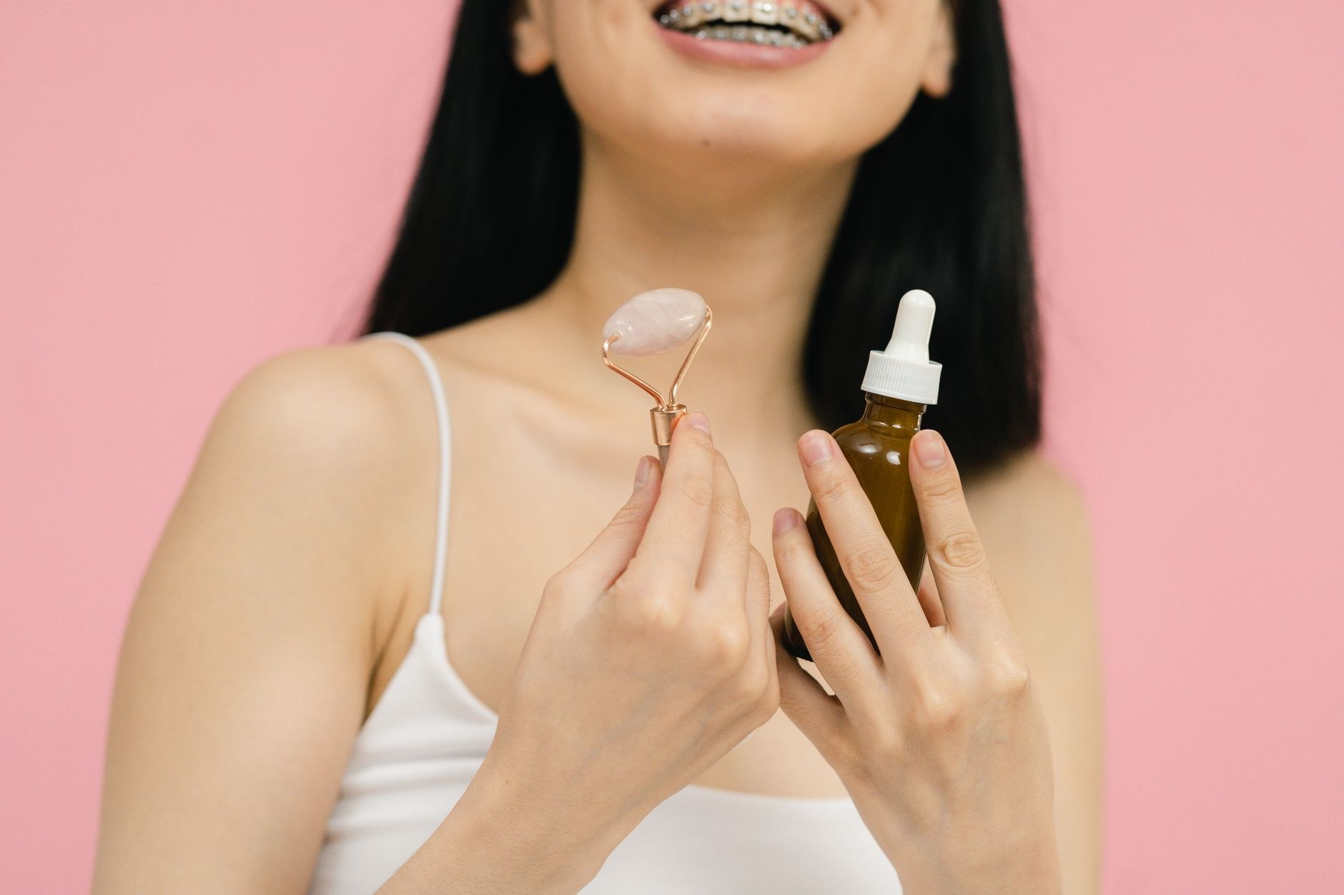 Facial serum and jade roller skincare detail